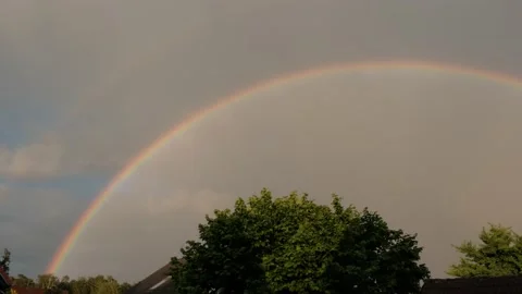 A beautiful large rainbow after the rain against the backdrop of an apartment Stock Footage 196855247