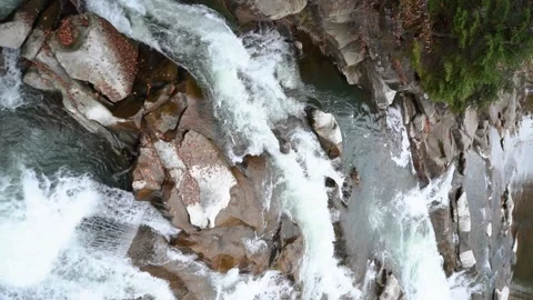 A beautiful large waterfall with cliffs high in the mountains. Travel and hike Stock Footage 325315895