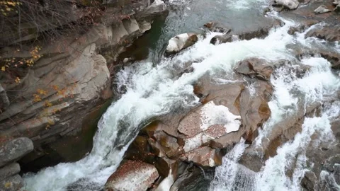 A beautiful large waterfall with cliffs high in the mountains. Travel and hike Stock Footage 325315898