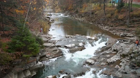 A beautiful large waterfall with cliffs high in the mountains. Travel and hike Stock Footage 325315903
