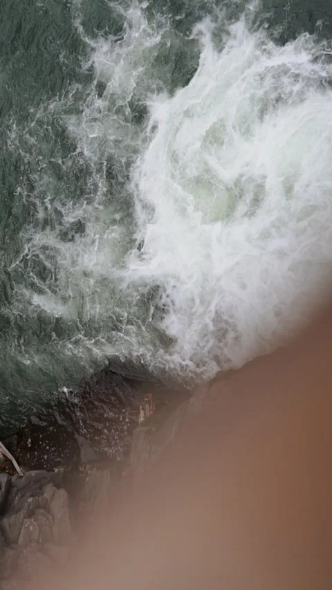 A beautiful large waterfall with cliffs high in the mountains. Travel and hike Stock Footage 325316162
