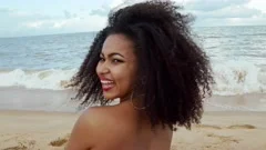 beautiful Latin American woman in bikini on the beach. Young woman