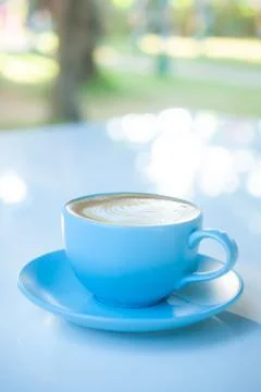 Beautiful latte art coffee cup on white table Stock Photos