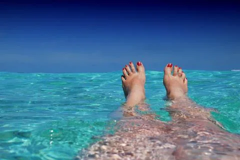 Beautiful legs swimming in the sea Stock Photos
