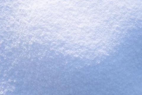 Beautiful light and shadow pattern. Hilly snow surface close-up in sunny day. Stock Photos