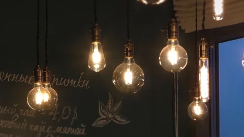 Beautiful light bulbs under the ceiling. Cafe interior. Close Stock Footage 129579384