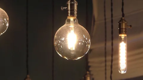 Beautiful light bulbs under the ceiling. Cafe interior. Close Video stock 129579446