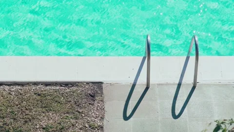 Beautiful light ripples on the water surface in the pool. Sun glare on turquoise Stock Footage 154711166