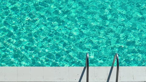 Beautiful light ripples on the water surface in the pool. Sun glare on turquoise Stock Footage 154822716