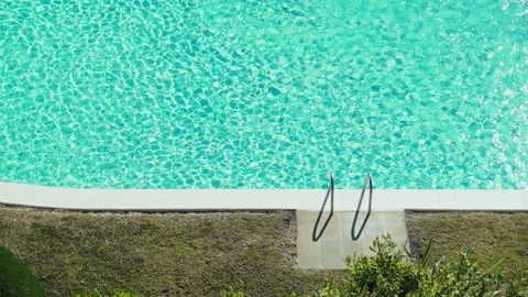 Beautiful light ripples on the water surface in the pool. Sun glare on turquoise Stock Footage 154823619