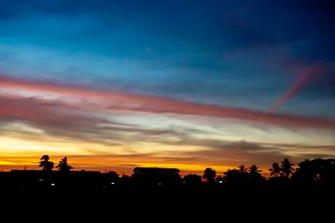 Beautiful light of Sunset with clouds in the sky reflection behind the buildi Stock Photos