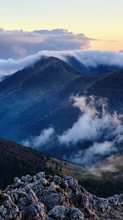 Beautiful light of twilight sky in wild misty nature with waves of low clouds in Stock-Footage 293778397