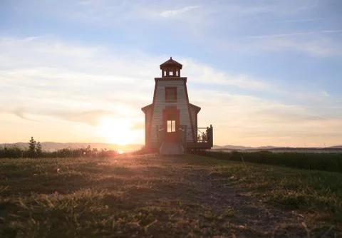 A beautiful lighthouse on a sunset background 스톡 사진