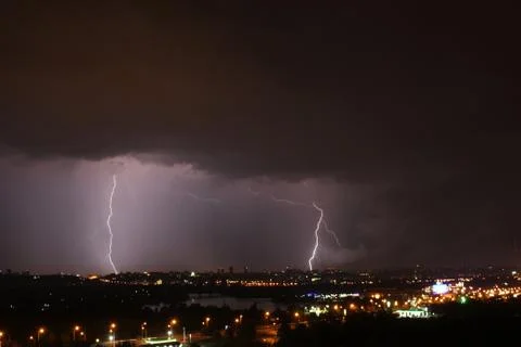Beautiful lightning above the night city Stock Photos
