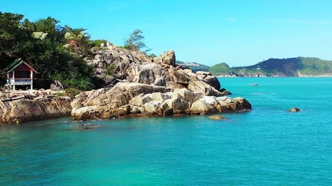 Beautiful limestone cliffs on coastline of tropical island washed by calm Stock Footage 126024932