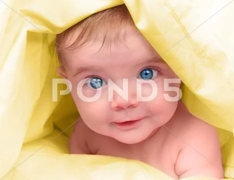 Beautiful little baby on yellow close up Stock Photos