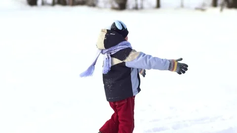 Beautiful little boy having fun playing in the snow. Stock Footage 81516657