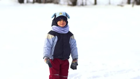 Beautiful little boy having fun playing in the snow. Video stock 81518697