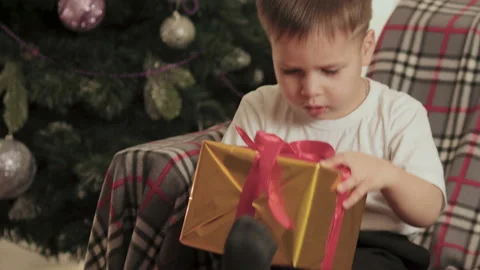 Beautiful, little boy opens his Christmas gift Video stock 112107664