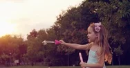 Beautiful Little Girl Enjoying Summer Day In Park Making Soap Bubbles Smiling Stock Footage
