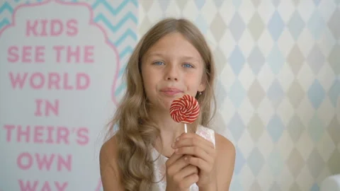 Beautiful little girl with lollipop, hap... | Stock Video | Pond5