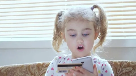 Beautiful Little Girl Online Banking Using Smartphone Shopping Online With Cr Stock Footage