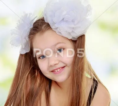 Beautiful little girl with white bows on the head Stock Photos