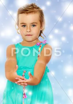 Beautiful little tanned girl in a blue dress. Stock Photos