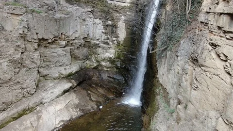 Beautiful little waterfall between massive cliffs, 4k Stock Footage 105565352