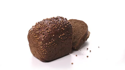 Beautiful loaf of black sliced bread, ready for breakfast with sprinkles spinn Stock Footage 148510453