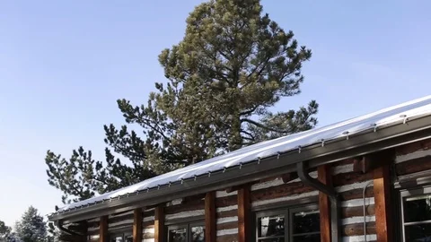 Beautiful Log Cabin with Large Pine Tree with Snow Stock Footage 76483962