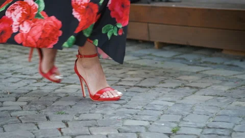 Beautiful long legs model walking around the city on heels in red shoes and a Stock Footage 138089695