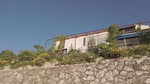 Beautiful low angle view of a seaside house on a sunny day Stock Footage 310946135