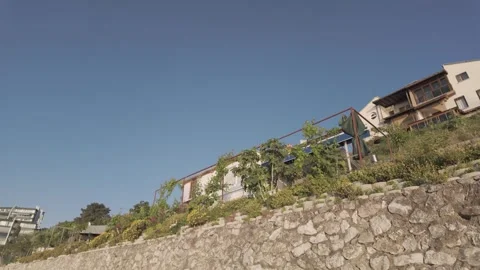 Beautiful low angle view of seaside houses on a sunny day Stock Footage 310946171