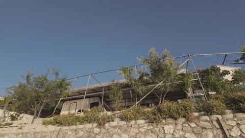 Beautiful low angle view of a seaside house on a sunny day Stock Footage 310946264