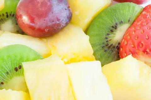 Beautiful macro background of fresh fruit salad on studio Stock Photos