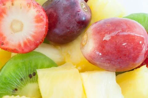 Beautiful macro background of fresh fruit salad on studio Stock Photos