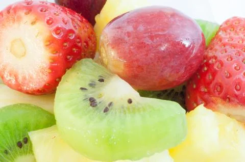 Beautiful macro background of fresh fruit salad on studio Stock Photos