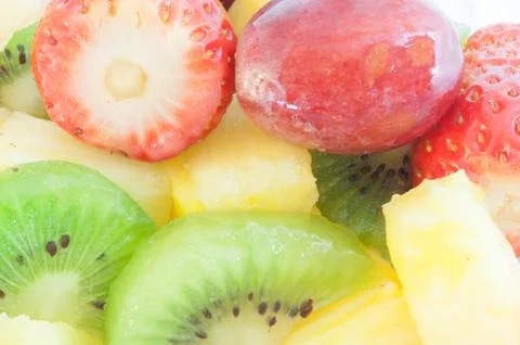 Beautiful macro background of fresh fruit salad on studio Stock Photos