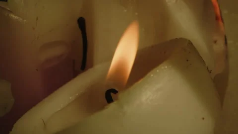 Beautiful macro of an burning candle and the orange fire being blown out in 스톡 동영상 336003677