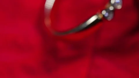 Beautiful Macro close up of gold ring with diamond on red leaf rotating around Video stock 70239618