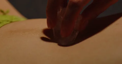 Beautiful macro of an ice cube teasingly being rubbed on the belly of an Stock Footage 279697609