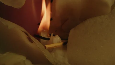 Beautiful macro of orange flames burning in slow motion on a pile of wax of a Video stock 336003088