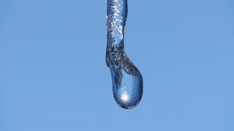 Beautiful macro on water drop with sunlight dripping from melting spring icicles Vídeo Stock 126068626
