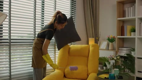 A beautiful maid is getting ready to clean the house, a maid is getting ready to Stock Footage 296670045