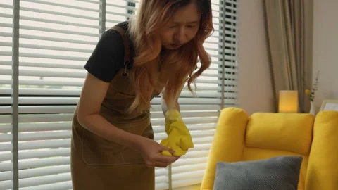 A beautiful maid is getting ready to clean the house, a maid is getting ready to Stock Footage 296670046