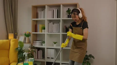 A beautiful maid is getting ready to clean the house, a maid is getting ready to Stock Footage 296670047