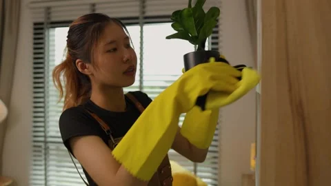 A beautiful maid is getting ready to clean the house, a maid is getting ready to Stock Footage 296670054