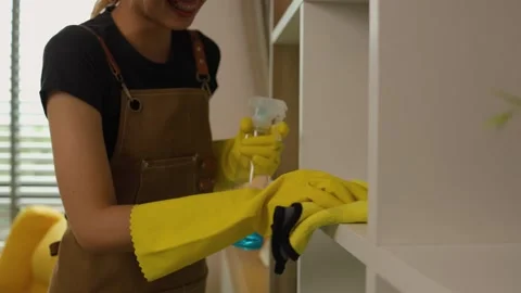 A beautiful maid is getting ready to clean the house, a maid is getting ready to Stock Footage 296670175