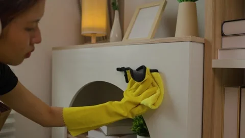 A beautiful maid is getting ready to clean the house, a maid is getting ready to Stock Footage 296670200